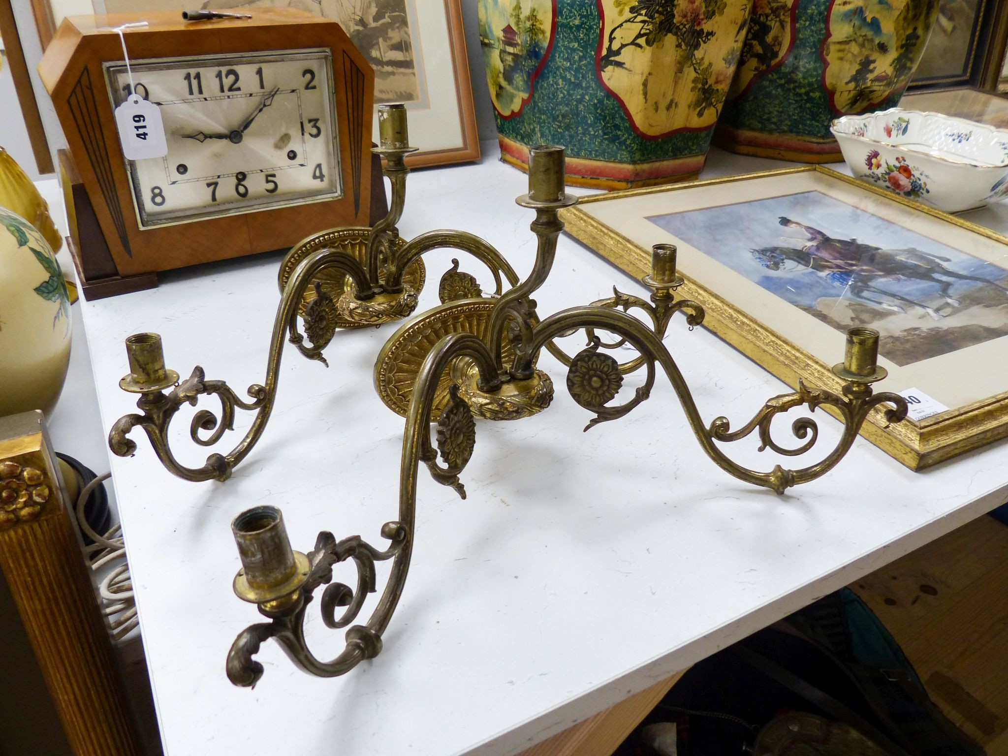 A pair of brass two-branch wall lights, 41 cm wide